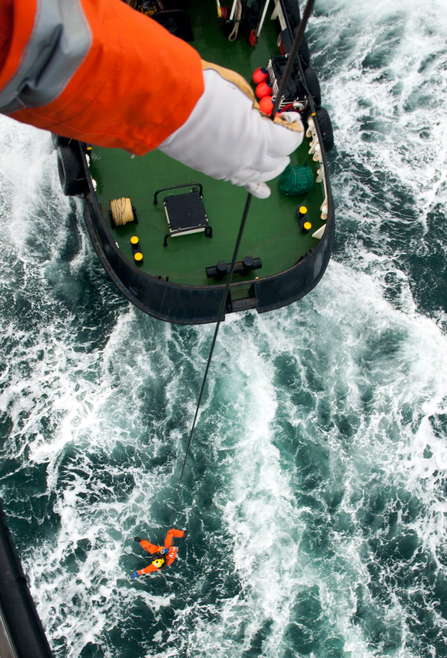 Image of a winchman on the end of a SAR helicopter cable